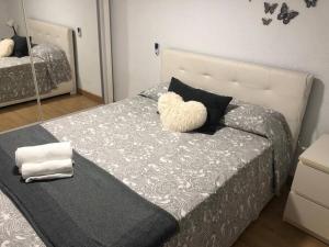 a bedroom with a bed with a stuffed animal on it at “Apartamento moderno y acogedor in Madrid