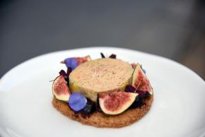 a dessert with fruit on a white plate at Royal Madeleine Hotel & Spa in Paris