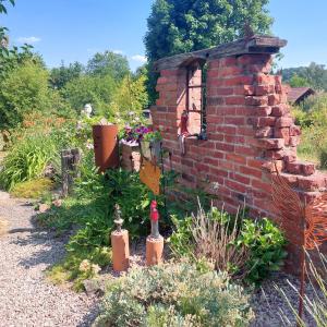 a brick wall with two wine bottles in a garden at Wolfi in Sankt Wendel +3 photos