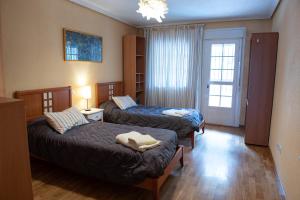 Postel nebo postele na pokoji v ubytování CASA DOVELA