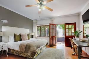 a bedroom with a bed and a ceiling fan at The River Guestroom in Krugersdorp