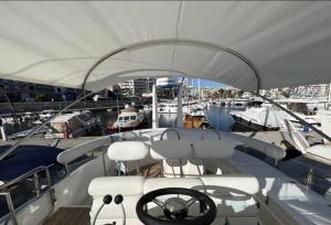 a boat docked in a marina with other boats at Bliss Motor yacht Fairline Squadron 52 in Piraeus