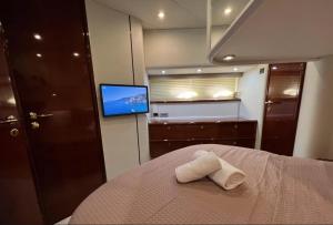 a bedroom with a bed with two towels on it at Bliss Motor yacht Fairline Squadron 52 in Piraeus