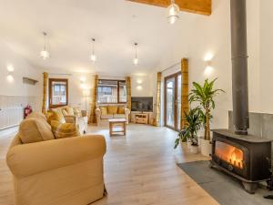 a living room with a couch and a fireplace at Lime Lodge - Uk42547 in Llanwrthwl