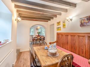 a dining room with a wooden table and chairs at Ty Newydd Y Graig - 28017 in Tremeirchion