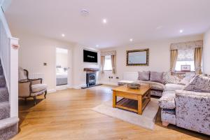 a living room with a couch and a table at Stunning 3-bed cottage in Beeston by 53 Degrees Property, ideal for Families & Groups, Great Location - Sleeps 6 in Beeston