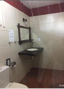 a bathroom with a sink and a toilet at Casa Cohiba in Cumbuco