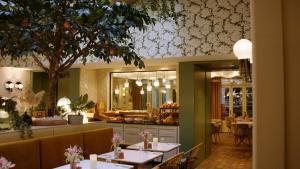 a restaurant with tables and chairs and a counter at Royal Madeleine Hotel & Spa in Paris