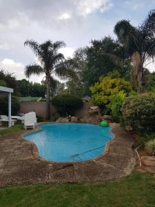 a small swimming pool in a yard with a patio at The Link on Elgin in Kempton Park