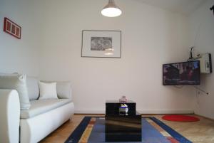 a living room with a couch and a table at Sunset Apartment Selce in Selce