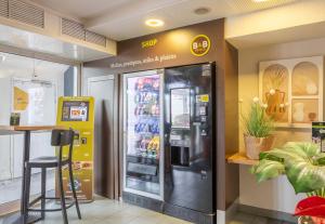 a grocery store with a refrigerator in a store at B&B HOTEL Toulon La Seyne sur Mer in La Seyne-sur-Mer