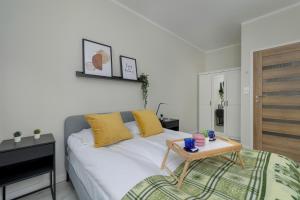 sypialnia z łóżkiem ze stołem w obiekcie Modern 2-Bedroom Apartment in Krakow by Renters w Krakowie
