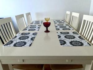 a table with a table cloth and a wine glass on it at Huttunen - Ihqu kolmio loistavalla sijainnilla in Iisalmi