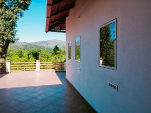 a patio of a house with mountains in the background at Memories of Malnad in Chikmagalūr