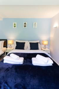 a bedroom with a large bed with two towels on it at Executive High-End Luxury Accommodation in Southampton, Perfect for Relocators, Contractors and Professionals in Southampton