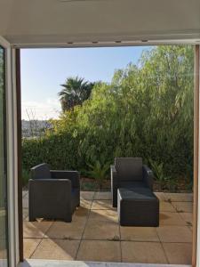 a patio with two chairs and a couch outside at Casa Porto Palo in Porto Palo +40 photos