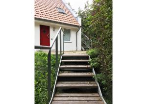 a staircase leading to a house with a red door at Ferienhaus Achter-Rachter in Mahlzow