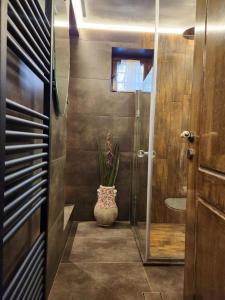 een badkamer met een vaas met een plant erin bij villa in Parnassos in Arachova