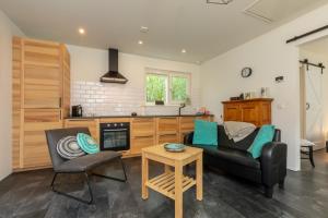 a living room with a couch and a table at Welcome in - Vakantiehuis - Achterweg 10 Zonnemaire ' Sol e Mar' in Zonnemaire +16 photos