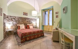 una camera con un letto e un muro in pietra di Amazing Home In Milo With Kitchen a Milo