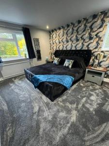 a bedroom with a bed and a stone wall at The Bainden , With Private Secluded Hot Tub in Rotherfield