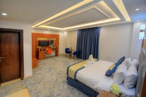 a hotel room with a bed and a television at فندق المرزم-Al Marzam Hotel in Al Madinah