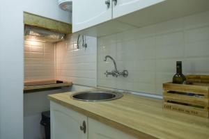 a kitchen with a sink and a bottle of wine at Lisbon Historic Center Apartment in Lisbon