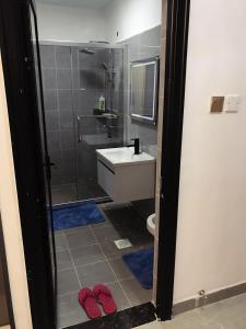 a bathroom with a shower and a sink and a toilet at Furnished apartment in Lavington in Nairobi +7 photos