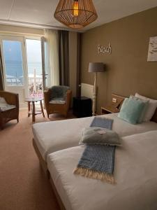 a hotel room with a bed with two pillows on it at Hotel Truida in Vlissingen