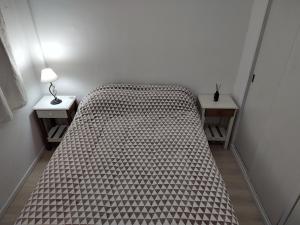 a bed in a room with two night stands at SANFER CENTER 2 in San Fernando
