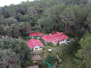 an aerial view of a house with a red roof at West View Hotel in Rānīkhet