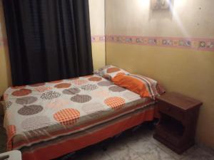 a small bedroom with a small bed and a window at La Casa Blanca in Salta