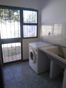 a bathroom with a washing machine and a sink at La Casa Blanca in Salta