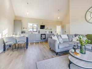 a living room with a couch and a table at The Warne - Uk45018 in Mochdre