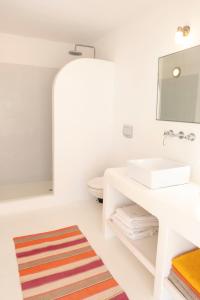 a bathroom with a sink and a mirror at Cycladic Villa Kamari in Kampos Paros