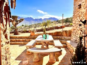 a table and benches on a patio with a view at VH CostaBlanca - CALIMA in Benissa