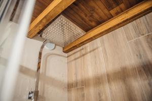 a bathroom with a shower and a wooden door at Casa da Fidalguinha in Ponte de Lima +17 photos