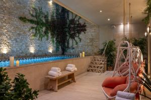 a bathroom with a swimming pool with a swing at Royal Madeleine Hotel & Spa in Paris