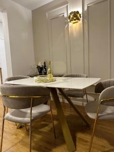a dining room with a white table and chairs at Lea Lux Apartment in Grude