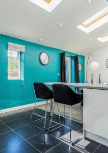 a dining room with blue walls and a table and chairs at 3 Bed House, Perfect for Business and Contractors in Nottinghamshire in Plumtree