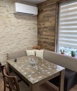 a dining room with a table and a couch at Уютен апартамент Мечта in Vratsa