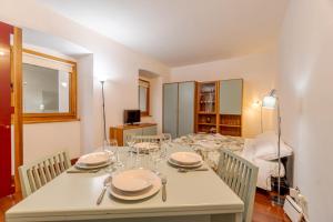 ein Esszimmer mit einem Tisch mit Tellern und Weingläsern in der Unterkunft Residenza Juvarra - Exclusive Flat in Turin