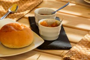 a table with a plate with a donut and a drink at B&B Fermata 106 da Carolina in Siculiana Marina