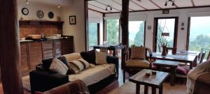 a living room with a couch and a table at Refugio Los Cipreses Hotel in Futaleufú