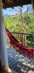a hammock on a porch with a view of a mountain at Casa Especial em Catas Altas in Catas Altas