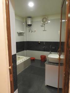 W łazience znajduje się wanna i umywalka. w obiekcie hp greenland resort w mieście Lataguri