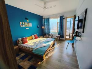 a bedroom with a bed with a blue wall at Blue Hills- B&B McleodGanj in Dharamshala