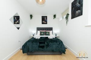 a bedroom with a large bed in a white room at Persephone Apartment - The Goddess of Town in Southampton