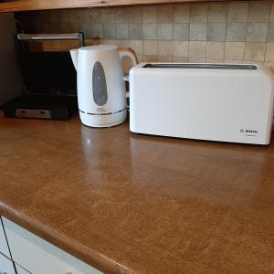 a white appliance sitting on a counter next to a toaster at Chalet De Ravers in Durbuy
