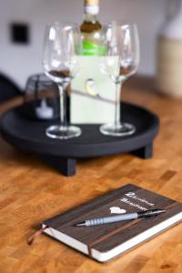 a black tray with two glasses and a bottle of wine at Résidence Beaufort in Zandvoort